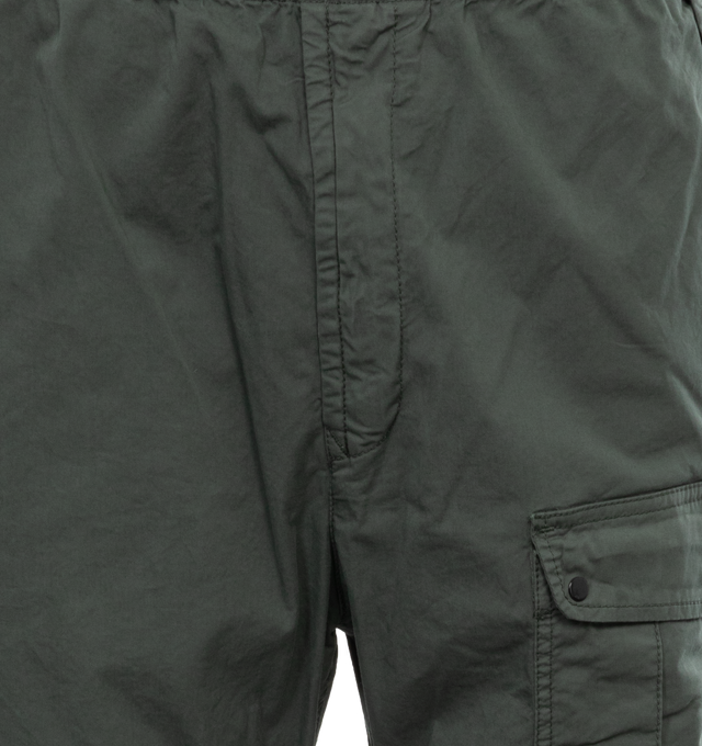 Image 4 of 4 - GREEN - STONE ISLAND Loose-Fit Cargo Pants featuring slanting hand pockets with slanted shaped flap and snap fastening, one patch bellows pocket on the back with shaped flap fixed on one side with a snap on the other side, big patch bellows pocket on the left leg, fixed on one side, snap on the other side, Stone Island badge, elasticized leg bottom and elasticized waistband with inner drawstring. 97% cotton, 3% elastane/spandex. 