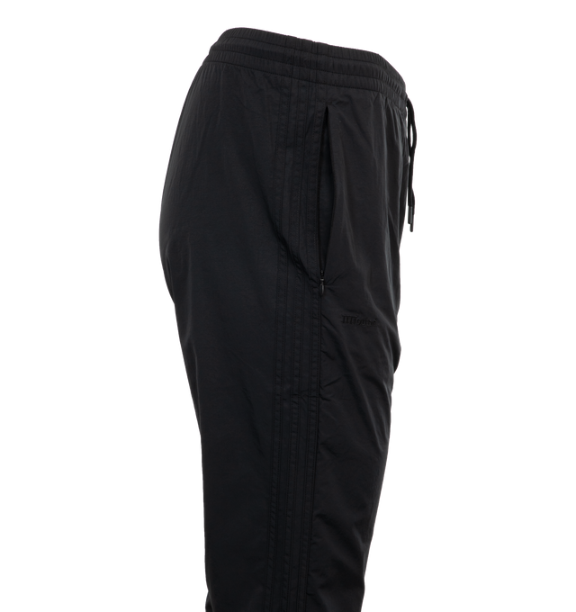 Image 3 of 4 - BLACK - ADIDAS JJJJound Nylon Track Pants featuring regular fit, drawcord on elastic waist, side pockets and ribbed cuffs. 100% recycled nylon plain weave.  