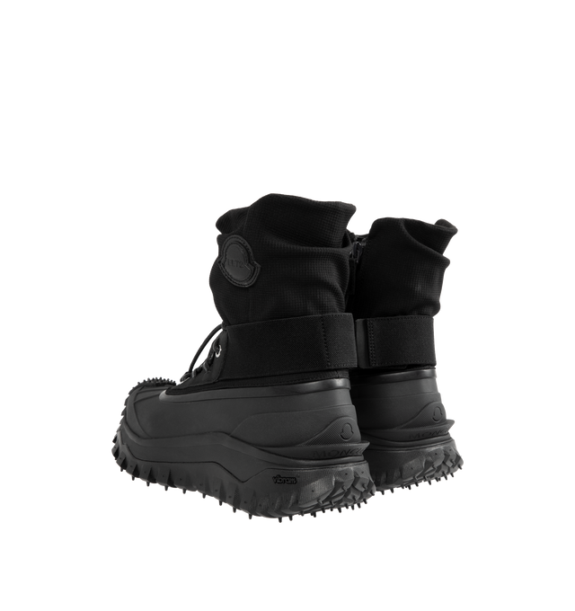 Image 3 of 4 - BLACK - Moncler x EE72 by Edward Enninful Trailgrip Storm Boots featuring stretch nylon, mesh in-sole, elastic and lace-up closure, TPU spoiler, EVA midsole and Special Vibram MEGAGRIP rubber compound tread. Calf height: 14 cm. Sole height: 4.5 cm. 100% polyamide. Sole: elastodiene. Made in Vietnam. 