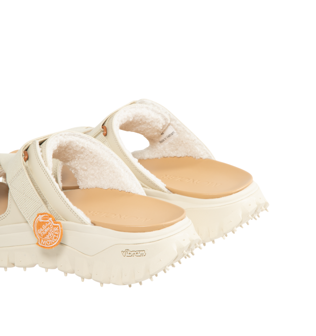 Image 3 of 4 - WHITE - Moncler x Gilga Farm Designed by Donald Glover Trailgrip Vela Leather Sandals featuring upper in leather and cotton, faux fur insole, EVA midsole, special Vibram MEGAGRIP rubber compound tread, EVA ergonomic insole and strap closure. Sole height 4.5 cm. Upper: 100% cotton. 100% cow. Lining: 100% polyester. Sole: 100% elastodiene. Made in Vietnam. 