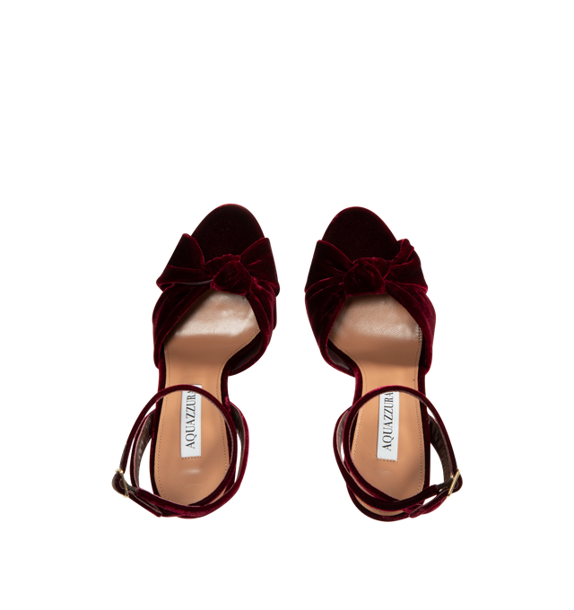 Image 4 of 4 - RED - Aquazzura Women's Cupid Plateau 130 Velvet Platform Heels are crafted from velvet and feature crossover straps with a knotted detail at the toe, an adjustable buckle ankle strap, and a round open-toe silhouette. Designed with a statement platform heel, this elevated sandal is finished with a leather lining and sole. Upper: Velvet. Lining: Leather. Sole: Leather. Heel Height: 130 mm / 5.1 in. Closure: Adjustable Buckle Ankle Strap. Toe: Round Open Toe. Made in Italy. 