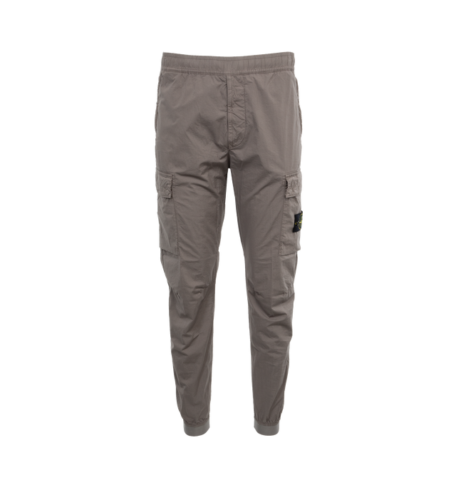 Image 1 of 4 - GREY - STONE ISLAND Tapered Pant featuring mid-rise, tapered leg, crinkled finish, signature detachable Compass badge, elasticated waistband with internal drawstring, concealed front zip fastening, two side zip-fastening pockets, rear press-stud fastening pocket, two side cargo pockets and elasticated cuffs. 