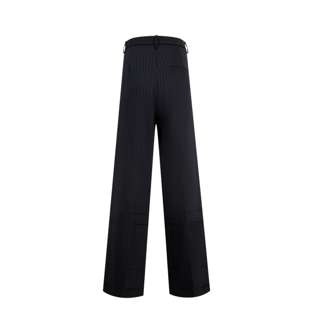 Image 2 of 3 - NAVY - KHAITE Linden Pant featuring a relaxed, wide-leg pant that reflects a deconstructive impulse with raw-edge paneling below the knee and pocket built into front pleat for a smooth fit. 96% virgin wool, 2% elastane, 2% cotton. 