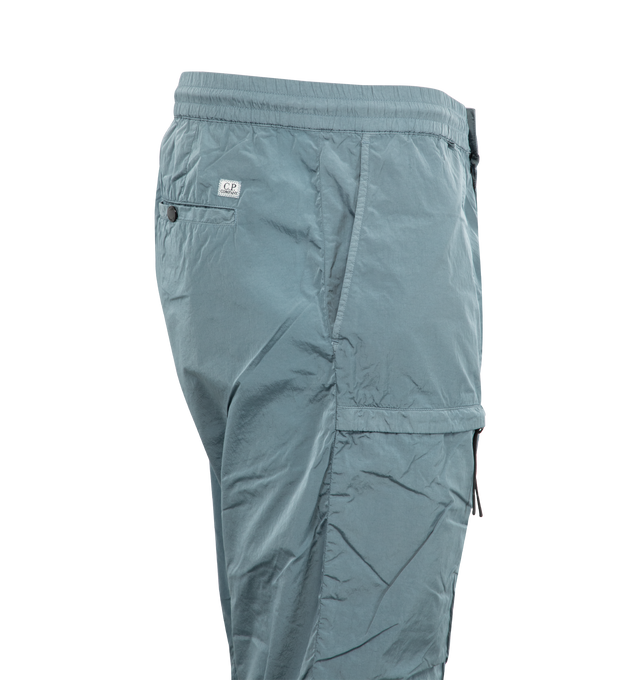 Image 3 of 4 - BLUE - C.P. COMPANY Chrome-R Cargo Lens Pants featuring adjustable drawstring waistband, button and zip fastening, side pockets, cargo flap snap and zip pockets, lens detail, back open pocket with applied logo label, adjustable drawstring hems, garment dyed and regular fit. 100% polyamide/nylon. 