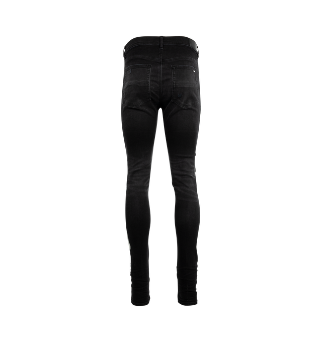 Image 2 of 4 - BLACK - AMIRI Bones Applique Distressed Jeans featuring white leather bones throughout side seams, distressed details throughout, tapered fit and ripped knees. 92% cotton, 6% elastomultiester, 2% elastane. 