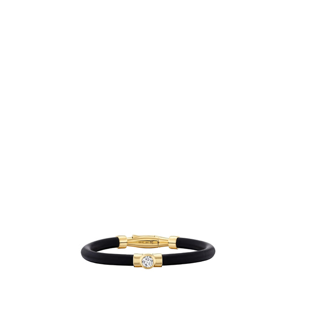 Image 1 of 3 - GOLD - Uniform Object Carbon Bracelet featuring 13 g of 18K yellow gold with a 5 mm round diamond (0.52 TCW) and round diamond accents. Handcrafted in New York City. Features an Italian-made hypoallergenic rubber band designed for comfort and durability. Hirshleifers offers a range of pieces from this collection in-store. For personal consultation and detailed information about jewelry, please contact our dedicated stylist team at personalshopping@hirshleifers.com. 