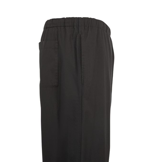 Image 3 of 3 - BLACK - The Row Men's Pascale Pant is crafted from lightweight Japanese wool twill and features a mid-rise pull-on silhouette with a loose, straight-leg fit. Designed with side seam pockets, a single back patch pocket, an adjustable drawstring waistband, and a button fly, this refined style balances technical performance with the rich drape and smooth handfeel of natural wool. Main Material: 100% Wool. Made in Italy. 