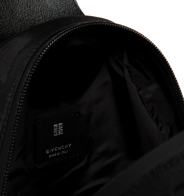 Image 3 of 3 - BLACK - GIVENCHY G-Trail Sling Bag featuring zipped closure, one adjustable padded Givenchy webbing strap to wear on the chest or as a small backpack, padded back for comfort, webbing strap on the front with reflective GIVENCHY signature and 4G buckle clip closure, decorative scratch on the front with Giv Cut signature and metal D-Ring, black and silvery-finish metal details, one main large compartment and two bottle compartments in mesh with drawstring on the sides. 7.87 in x 11.02 in x 3.54 