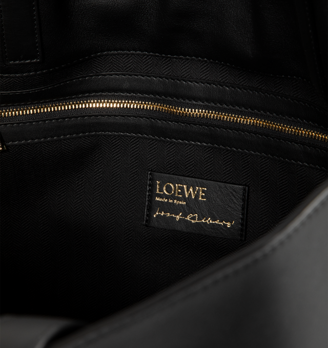 Image 3 of 3 - BLACK - LOEWE XL Flamenco Clutch in nappa calfskin featuring a cinched closure, historical knot drawstrings, shoulder carry, top handles, magnetic closure, one internal zipped pocket, textile lining and gold embossed logo. Nappa calf. 34.5 cm x 44.7 cm x 21.5 cm. Made in Spain. 