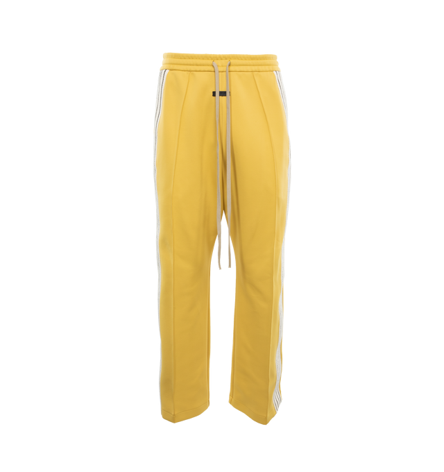 Image 1 of 4 - YELLOW - FEAR OF GOD Stripe Relaxed Sweatpant featuring a relaxed fit with a pintuck stitch to shape the leg and a sports-inspired canvas side stripe, pockets, encased elastic waistband, elongated drawstrings and Fear of God leather label at the center front. 60% nylon, 40% cotton. 
