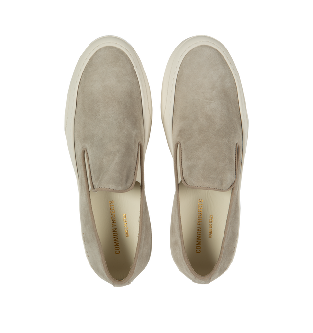 Image 5 of 5 - NEUTRAL - Common Projects minimalist slip-on sneaker crafted from calf suede in a sleek, round-toe profile with thick rubber soles detailed at the heels with signature gold serial number stamp. Made in Italy. 