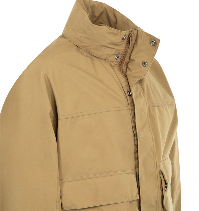 Image 4 of 4 - BROWN - LEMAIRE Short Rain Parka featuring water-repellent VENTILE cotton, boxy fit, lightweight unlined hooded model, high collar with drawstring, long sleeves with buttoned tabs, concealed zip and snap fastening, deep flap patch pockets, adjustable drawstrings at waist and VENTILE collaboration label inside. 100% cotton. Made in Romania. 