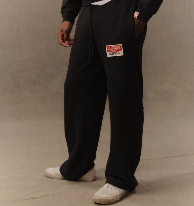 Image 5 of 6 - BLACK - Cherry LA Chevron Parachute Sweatpants are crafted from custom cotton fleece and feature a wide-leg silhouette with a relaxed, laid-back fit. Designed with a patch detail at the leg, an adjustable drawcord waistband, and a branded label at the back pocket, these everyday sweatpants blend comfort-focused construction with Cherry LA's signature contemporary aesthetic. Main Material: Custom Cotton Fleece. Made in Los Angeles, USA. 