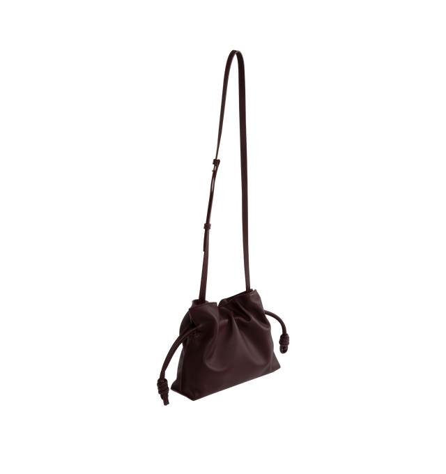 Image 2 of 3 - PURPLE - LOEWE Flamenco Mini Napa Drawstring Clutch Bag featuring suede lining, coiled knot drawstring and hidden magnetic closure. 7"H x 9.4"W x 3.5"D. Convertible shoulder strap: 11 1/2" 23 1/2" drop. Nappa calf. Made in Spain. 