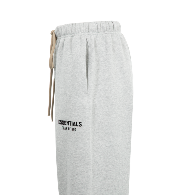 Image 3 of 3 - GREY - Fear of God Essentials Womens Sweatpants have an elastic drawstring waistband, side pockets, and a graphic screen printed on the leg. 