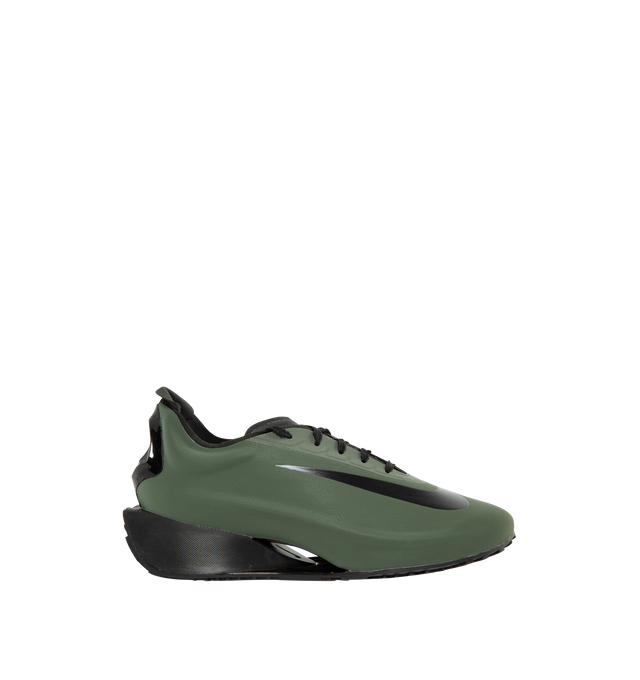 Image 1 of 5 - GREEN - Nike Women's First Sight Noir Sneakers are crafted from a sleek one-piece upper and feature a sculptural silhouette inspired by Nike's running heritage. Designed as the debut style in the First Sight collection, this fashion-forward sneaker is defined by a circular heel cutout, a thick angular foam midsole, and bold branding details that blend athletic performance with modern statement styling. Main Material: Synthetic Upper. Midsole: Soft Foam Cushioning. Closure: Lace-Up. Details: O 