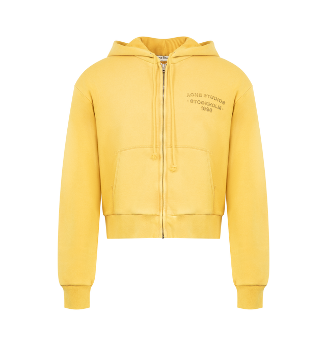 Image 1 of 2 - YELLOW - Acne Studios Hooded Sweatshirt featuring sprayed cotton fleece, regular unisex fit, waist-length, long sleeves, zip-up front, drawcord hood, ribbed cuffs and hem, kangaroo pockets and Acne Studios 1996 logo stamp on chest. 100% cotton. 