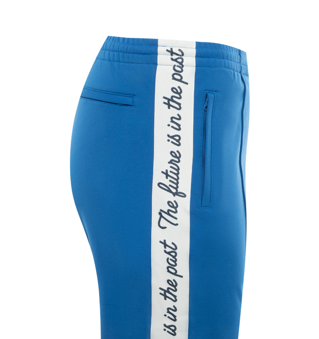 Image 3 of 3 - BLUE - HUMAN MADE Track Pants featuring the character graphic of "THE FUTURE IS IN THE PAST" on both sides, elastic waist, two side pockets and one back welt pocket. 100% polyester. 