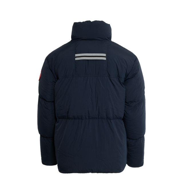 Image 2 of 3 - NAVY - CANADA GOOSE Lawrence Water Repellent 750 Fill Power Down Puffer Jacket featuring two-way front-zip closure, stand collar, inset ribbed cuffs, hidden side-zip pockets, interior zip pocket, interior mesh drop-in pockets, interior shoulder straps for hands-free carry, reflective details enhance visibility in low light or at night, water-repellent and lined with 750-fill-power down fill. 100% recycled nylon. Made in Canada. 