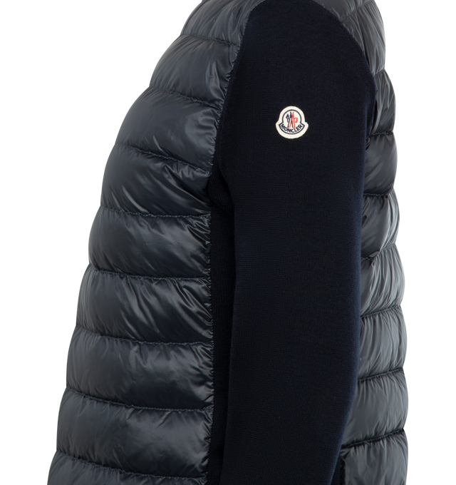 Image 3 of 3 - NAVY - MONCLER Padded Wool Zip-Up Cardigan featuring an attached drawstring hood, front zip closure, channel-quilted body, ribbed cuffs and hem, zip pockets, flap sleeve pocket, and logo patch detail. Lined body and hood. 100% polyamide/nylon. Padding: 90% down, 10% feather. 