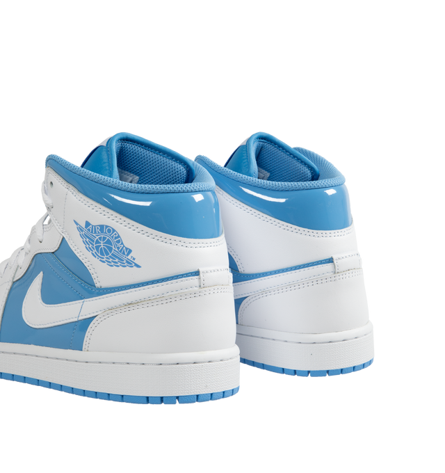 Image 3 of 5 - BLUE - AIR JORDAN 1 MID SE basketball shoe in white and Legend Blue leather upper featuring an angled profile, toe box perforations, mesh tongues and lining, encapsulated Air cushioning underfoot, and distinctive Jordan detailing. Air-Sole cushioning provides lightweight, responsive comfort.  Leather and textile upper/synthetic lining/rubber sole. 