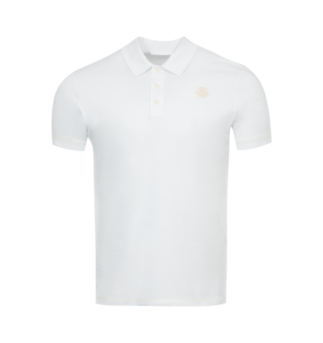 Image 1 of 2 - WHITE - MONCLER Logo Polo Shirt featuring collar, Mother-of-pearl buttons, short sleeves, ribbed cuffs and collar and logo. 100% cotton. 