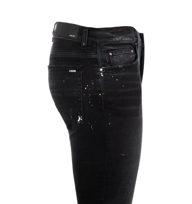 Image 3 of 3 - BLACK - Amiri Vintage Patch Skinny Jenas are a 5-pocket style with a button fly closure, a distressed and ripped finish, and a logo patch at the rear. Made in USA.  