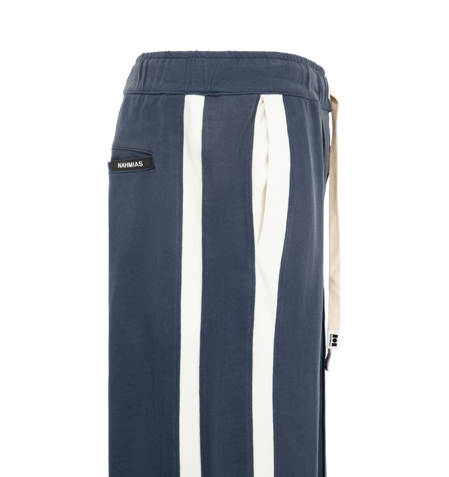 Image 3 of 4 - NAVY - Nahmias Men's Heavy Cotton Track Pant is crafted from cotton and features an elasticized waistband with signature Nahmias drawcords, contrast piping and track stripes along the sides, and zip openings at the hems. Designed and made in Los Angeles, this relaxed track pant combines a worn-in finish with sport-inspired detailing. Main Material: 100% Cotton.  