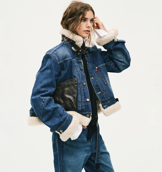 Image 5 of 5 - BLUE - Sacai X Levi's Women's Belted High-Rise Flare-Leg Jeans are crafted from a medium-wash cotton denim and feature a high-rise waist, flare-leg silhouette, a buckled belt, signature Levi back-pocket design, and utility-inspired patch pockets. Main Material: 100% Cotton.  Made in Japan. 