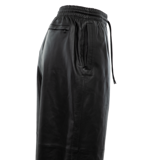 Image 3 of 4 - BLACK - WARDROBE.NYC Leather Track Pant featuring a relaxed fit, elasticated waist with drawcords and zipped pockets. 100% leather. Lining: 100% cotton. Made in France. 
