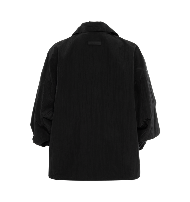 Image 2 of 2 - BLACK - FEAR OF GOD ESSENTIALS Shell Bomber featuring a cropped and rounded silhouette, a classic shirt collar, a rubber brand label at the upper back, a full zipper front closure, and a toggle bungee elastic hem for a customizable fit. 86% woven nylon, 14% spandex. 