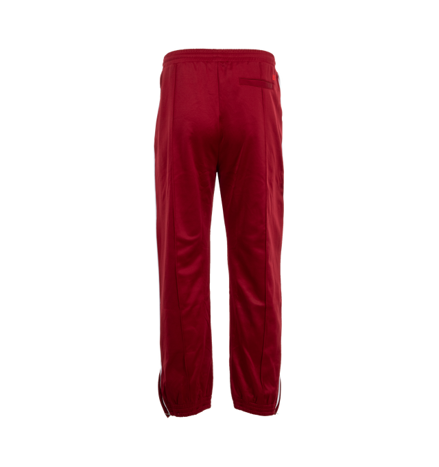 Image 2 of 3 - RED - Wales Bonner Men's Essence Track Pants are crafted with an elegant front pleat and contrast piping on the side-seam. An elasticated cuff and adjustable zip at the hem allow for versatile styling. Made in Portugal. 55% Polyester, 45% Cotton. 