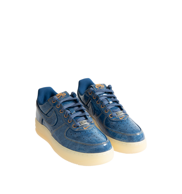 Image 2 of 5 - BLUE - Nike Men's Air Force 1 Low Retro Premium Sneaker featuring patent leather denim upper with perforated toe box, Nike Air technology and rubber outsole with heritage hoops pivot circles. 