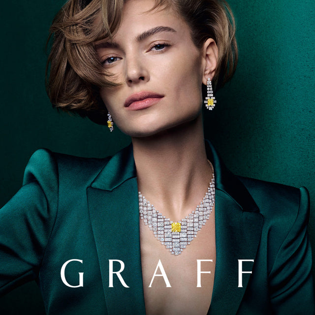 Model wearing Graff diamond jewelry against a green background 