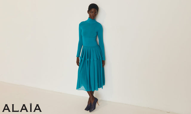 Woman wearing a teal dress by Alaia
