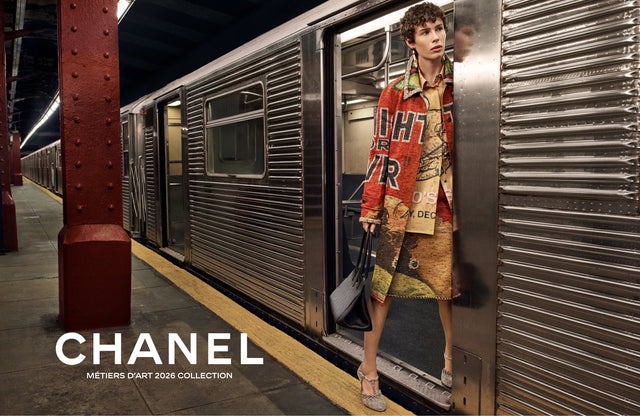 Person exiting a subway train wearing Chanel with Chanel logo