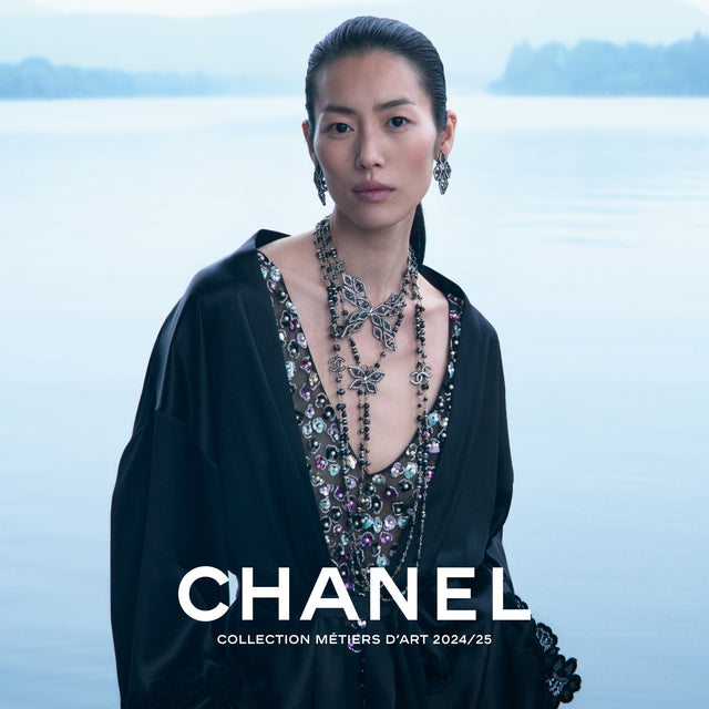 WOMAN WEARING CHANEL BEADED TOP, LAYERED NECKLACES AND EARRINGS 