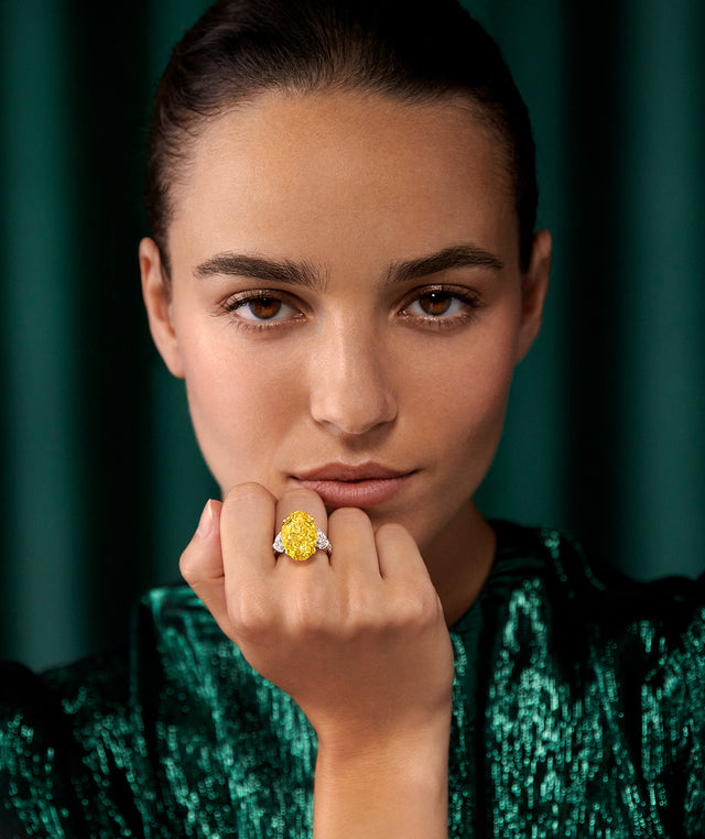 Woman wearing a yellow ring by Graff Diamond Jewelry 
