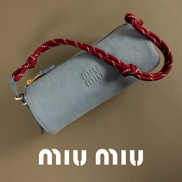 Gray pouch with red strap on a brown background, featuring the Miu Miu logo. 