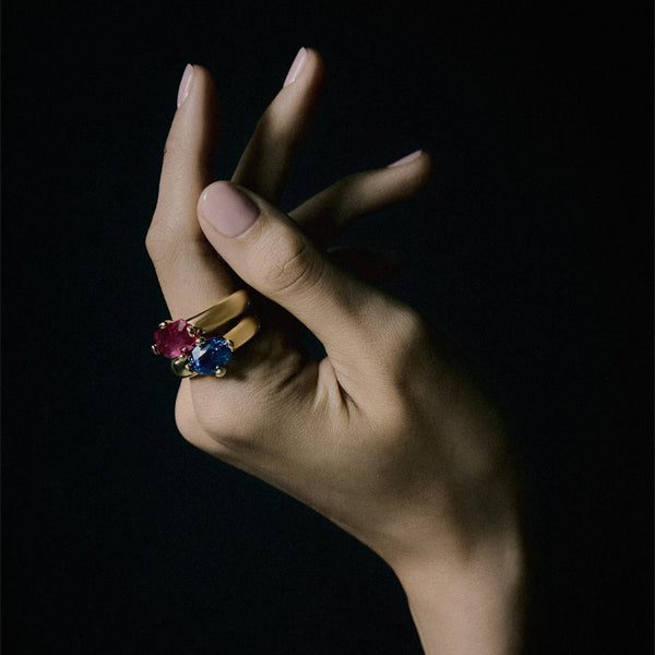 Hand wearing Uniform Object gold rings with ruby and sapphire