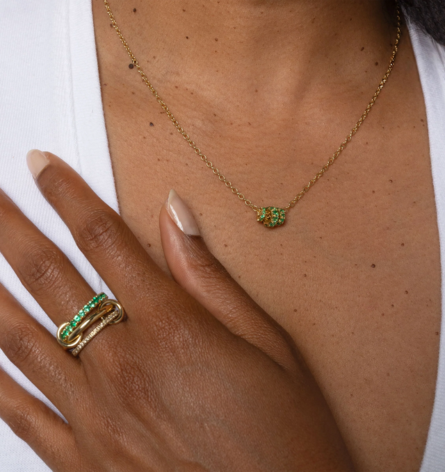 Image 2 of 2 - GOLD - Spinelli Kilcollin Vesta YG Emerald Necklace is crafted from 18k yellow gold and features a trio of signature full-round annulets that move freely along the chain. Designed with emerald accents and inspired by the brand's iconic linked silhouettes, this refined necklace blends sculptural elegance with everyday wearability. The adjustable chain measures 18 inches and includes a shortening link for a 16-inch fit. Main Material: 18k Yellow Gold. Details: Three Full-Round Annulets in 1.7 m 