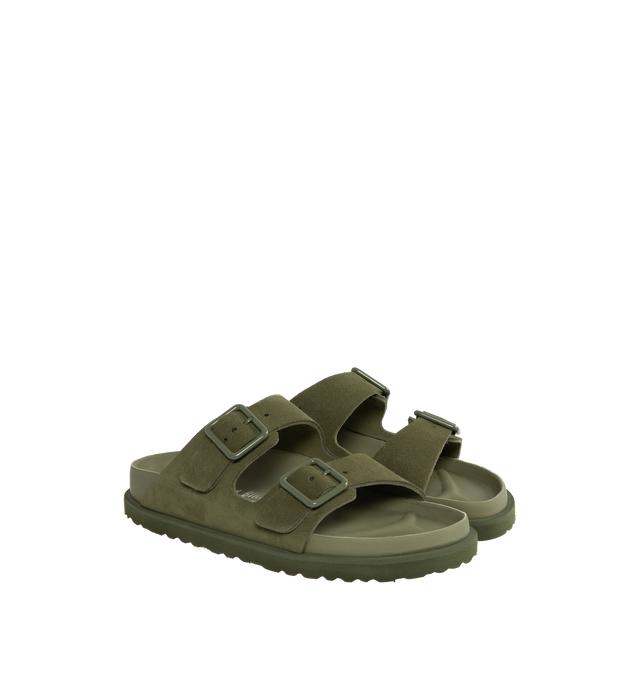 Image 2 of 4 - GREEN - Birkenstock's Arizona sandals in a narrow width. The iconic Arizona sillhouette is  updated in suede featuring adjustable straps with buckle closures, logo details, shaped insole, and EVA outsole. Upper: Luxurious fine flesh out suede, a full grain leather that has been flipped to use the fuzzy side. Footbed: Anatomical shaped BIRKENSTOCK cork-latex footbed, covered with premium, color-matching smooth nappa leather. Sole: EVA outsole with a 3mm EVA welt updates the standard die-cut ou 