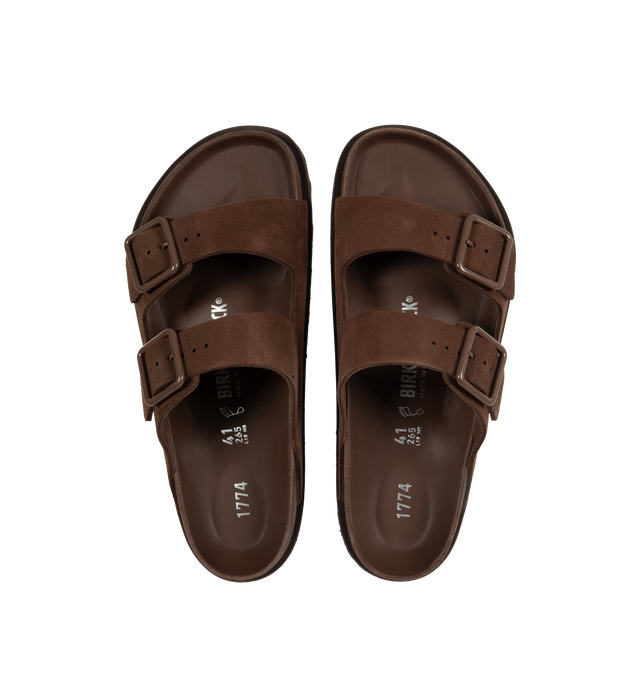 Image 4 of 4 - BROWN - Birkenstock's Arizona sandals in a regular width. The iconic Arizona sillhouette is  updated in suede featuring adjustable straps with buckle closures, logo details, shaped insole, and EVA outsole. Upper: Luxurious fine flesh out suede, a full grain leather that has been flipped to use the fuzzy side. Footbed: Anatomical shaped BIRKENSTOCK cork-latex footbed, covered with premium, color-matching smooth nappa leather. Sole: EVA outsole with a 3mm EVA welt updates the standard die-cut o 