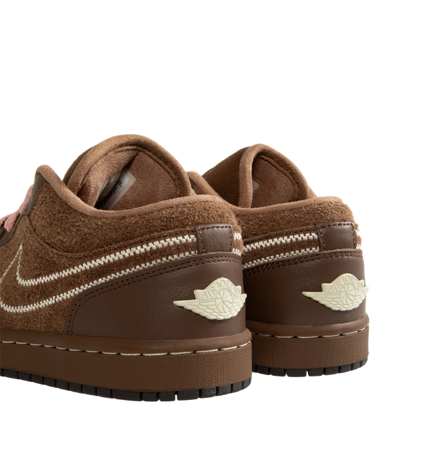 Image 3 of 5 - BROWN - Air Jordan 1 Low SE Women's Shoes pair the timeless design of the original AJ1 with premium materials and everyday comfort. Crafted with a genuine leather upper, this low-top silhouette is designed with Nike Air cushioning and a foam midsole for lightweight support, while a durable rubber outsole provides reliable traction. Main Material: Genuine Leather Upper. Cushioning: Nike Air Technology with Foam Midsole. Outsole: Rubber. 