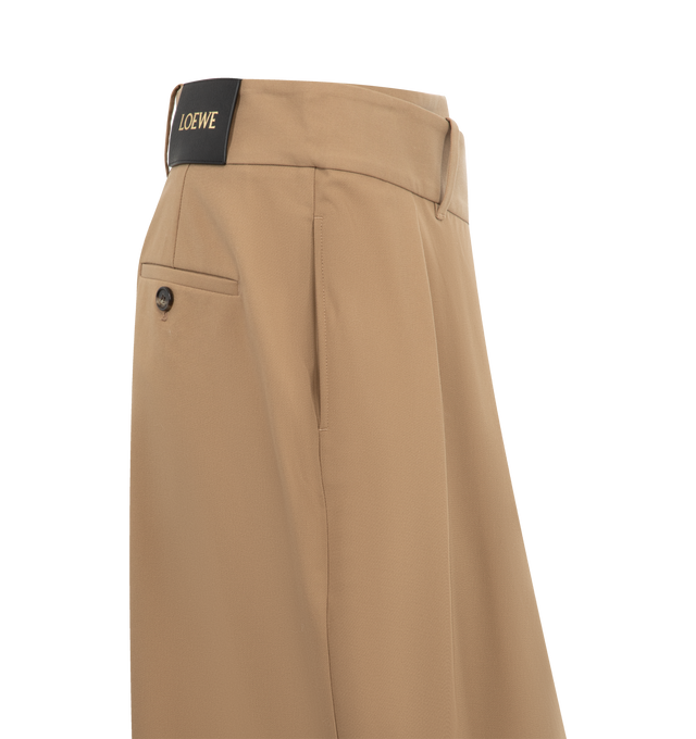 Image 3 of 3 - BROWN - LOEWE Wrap Skirt in lightweight compact cotton twill featuring an asymmetric construction with a wrap front, regular fit, mid length, mid waist, concealed hook fastening, seam pockets, buttoned rear welt pocket, pleats at the front and LOEWE embossed leather patch placed at the back. Cotton. Made in Italy. 