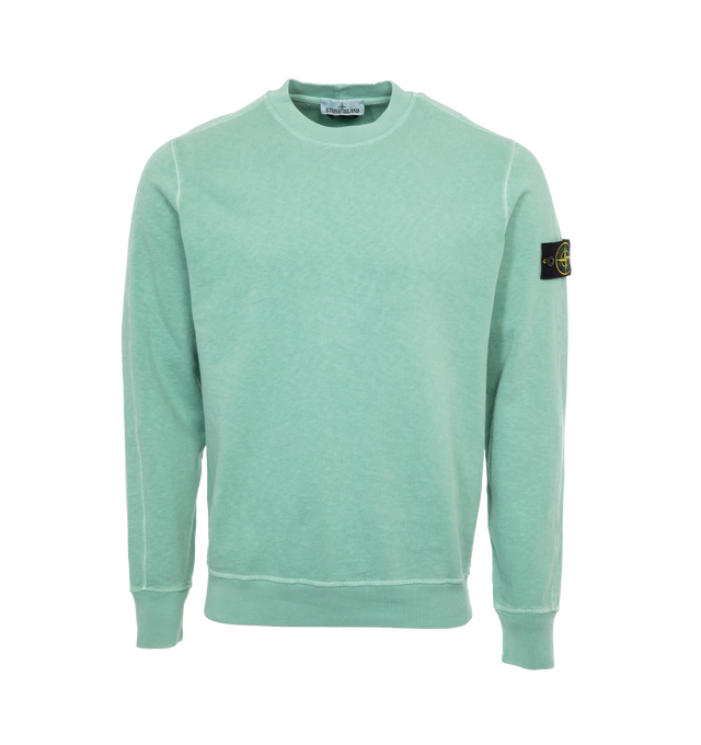 Image 1 of 2 - GREEN - STONE ISLAND Crewneck Sweatshirt featuring rib knit crewneck, hem, and cuffs and detachable logo patch at sleeve. 100% cotton. Made in Turkey. 