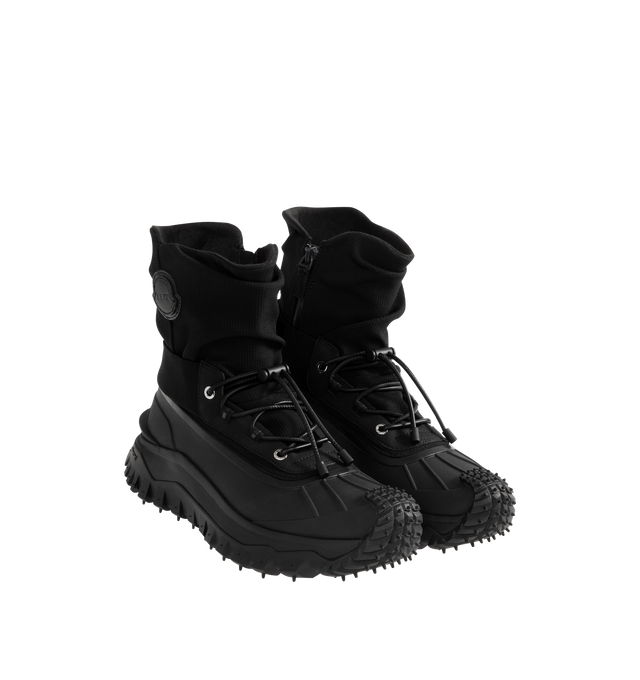 Image 2 of 4 - BLACK - Moncler x EE72 by Edward Enninful Trailgrip Storm Boots featuring stretch nylon, mesh in-sole, elastic and lace-up closure, TPU spoiler, EVA midsole and Special Vibram MEGAGRIP rubber compound tread. Calf height: 14 cm. Sole height: 4.5 cm. 100% polyamide. Sole: elastodiene. Made in Vietnam. 