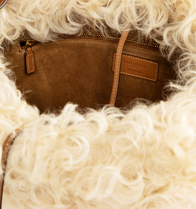 Image 3 of 3 - BROWN - SAINT LAURENT Roady Shoulder Bag featuring suede exterior and lining with dyed shearling trim, magnetic snap closure at the top, one main compartment with one zip pocket and two interior slip pockets. 13" W x 11.8" H x 3.9" D. Made in Italy. 