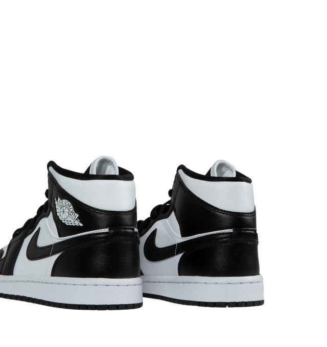 Image 3 of 5 - BLACK - JORDAN Air Jordan 1 Mid featuring genuine and synthetic leathers, padded tongue and inner upper, iconic winged Air Jordan logo on upper, encapsulated Air unit, Solid rubber outsole, stitched-down Swoosh logo and wings logo on the collar. 