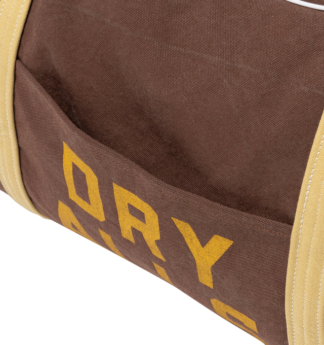 Image 5 of 8 - BROWN - HUMAN MADE Canvas Boston Bag Large featuring thick, tough cotton canvas, bio-washed for a vintage-like feel, graphics appear on both sides, external pocket and an internal zip pocket, heart-shaped rivets and 100L capacity. 100% cotton.  